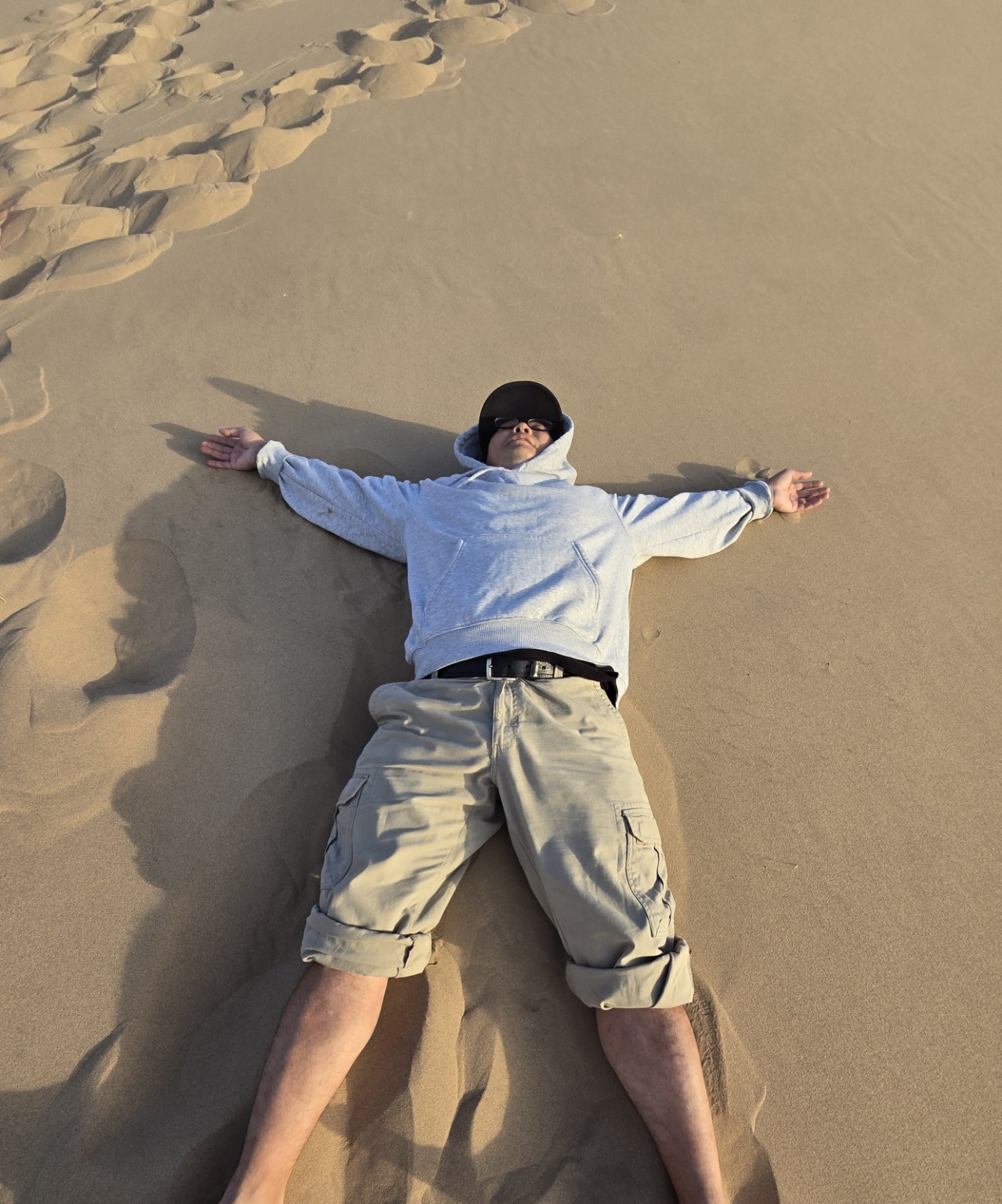 Traveler relaxing on a sand dune